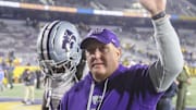Oct 19, 2024; Morgantown, West Virginia, USA; Kansas State Wildcats head coach Chris Klieman celebrates with fans after defeating the West Virginia Mountaineers at Mountaineer Field at Milan Puskar Stadium. Mandatory Credit: Ben Queen-Imagn Images