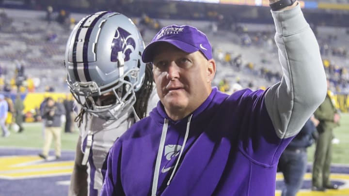 Oct 19, 2024; Morgantown, West Virginia, USA; Kansas State Wildcats head coach Chris Klieman celebrates with fans after defeating the West Virginia Mountaineers at Mountaineer Field at Milan Puskar Stadium. Mandatory Credit: Ben Queen-Imagn Images