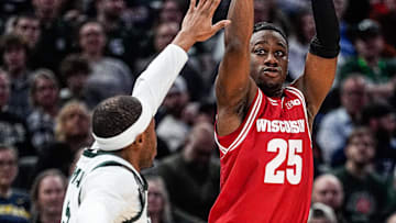 Wisconsin guard John Blackwell (25) shoots a three point basket against Michigan State guard Tre Holloman (5) during the first half of Big Ten Tournament semifinal at Gainbridge Fieldhouse in Indianapolis, Ind. on Saturday, March 15, 2025.