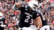 Cincinnati Bearcats quarterback Brendan Sorsby (2) jumps over Northwestern State Demons cornerback Antonio Hall (2) in the second quarter of a NCAA men’s college football game between the Cincinnati Bearcats and Northwestern State Demons, Saturday, Sept. 13, 2025, at Nippert Stadium in Cincinnati. Bearcats are up 56-0 by halftime.