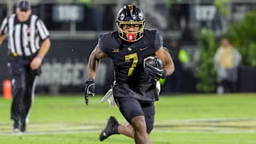 Nov 29, 2024; Orlando, Florida, USA; UCF Knights running back RJ Harvey (7) runs the ball during the second quarter against the Utah Utes at FBC Mortgage Stadium. 