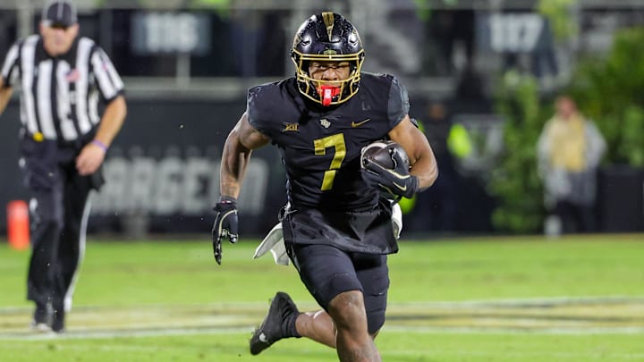 Nov 29, 2024; Orlando, Florida, USA; UCF Knights running back RJ Harvey (7) runs the ball during the second quarter against the Utah Utes at FBC Mortgage Stadium. Nov 29, 2024; Orlando, Florida, USA; UCF Knights running back RJ Harvey (7) runs the ball during the second quarter against the Utah Utes at FBC Mortgage Stadium.