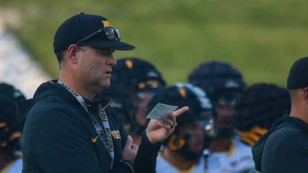 Missouri Tigers receivers coach Jacob Peeler looks onto his play sheet at the team's annual fan night practice at Faurot Fiel