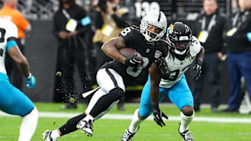 Dec 22, 2024; Paradise, Nevada, USA; Las Vegas Raiders running back Ameer Abdullah (8) gains yardage ahead of Jacksonville Jaguars linebacker Devin Lloyd (33) during the second quarter at Allegiant Stadium. Mandatory Credit: Stephen R. Sylvanie-Imagn Images