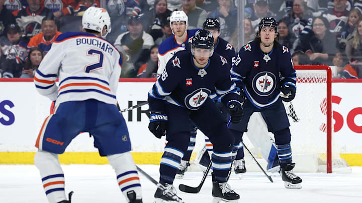 Apr 13, 2025; Winnipeg, Manitoba, CAN; Winnipeg Jets center Morgan Barron (36) blocks a shot from Edmonton Oilers defenseman Evan Bouchard (2) in the second period at Canada Life Centre. Mandatory Credit: James Carey Lauder-Imagn Images