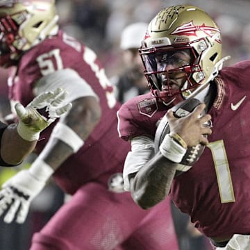 Nov 15, 2025; Tallahassee, Florida, USA; Florida State Seminoles quarterback Thomas Castellanos (1) runs the ball past Virginia Tech Hokies defensive lineman Kelvin Gilliam Jr. (22) during the first half at Doak S. Campbell Stadium. Mandatory Credit: Melina Myers-Imagn Images