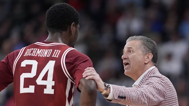 Arkansas Razorbacks coach John Calipari talks to forward Billy Richmond III (24) during the second half of a second round 