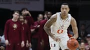 Jan 17, 2024; Coral Gables, Florida, USA; Miami Hurricanes guard Matthew Cleveland (0) dribbles the basketball against the Florida State Seminoles during the second half at Watsco Center. Mandatory Credit: Sam Navarro-Imagn Images
