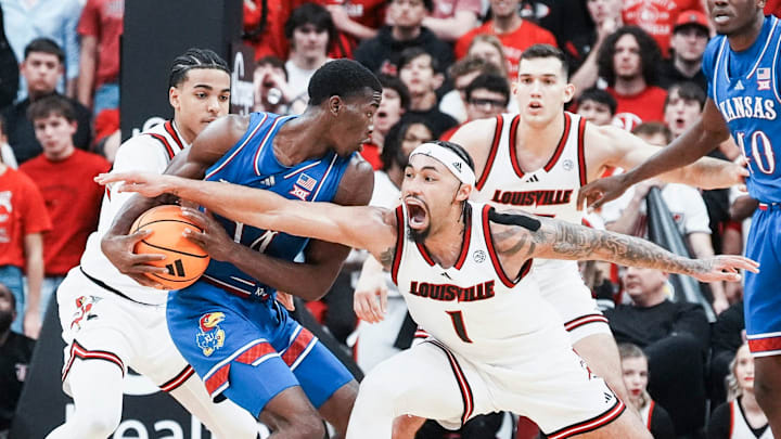 Louisville Cardinals guard J'Vonne Hadley (1) tries to steal the ball from Kansas Jayhawks guard Melvin Council Jr. (14) in the exhibition game at the KFC Yum! Center in Louisville, Kentucky Friday, October 24, 2025.