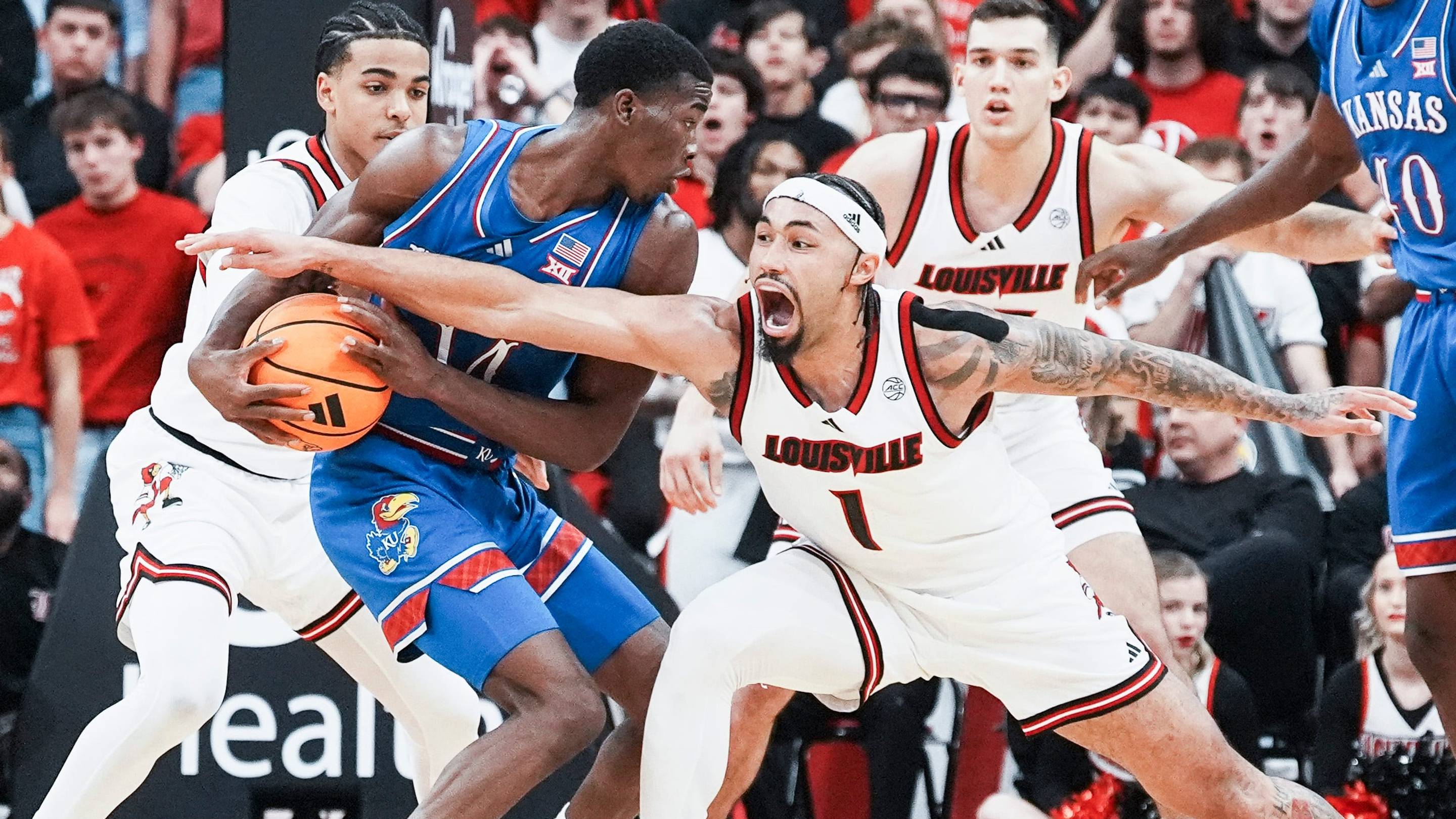Louisville Cardinals guard J'Vonne Hadley (1) tries to steal the ball from Kansas Jayhawks guard Melvin Council Jr. (14) in the exhibition game at the KFC Yum! Center in Louisville, Kentucky Friday, October 24, 2025. | USA TODAY Network via Reuters Connect