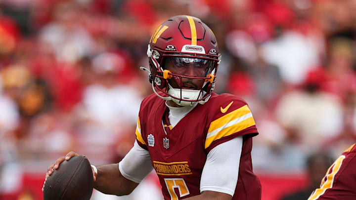 Sep 8, 2024; Tampa, Florida, USA; Washington Commanders quarterback Jayden Daniels (5) drops back to pass against the Tampa Bay Buccaneers in the third quarter at Raymond James Stadium. Mandatory Credit: Nathan Ray Seebeck-Imagn Images