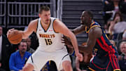 Apr 4, 2025; San Francisco, California, USA;  Denver Nuggets center Nikola Jokic (15) is guarded by Golden State Warriors forward Draymond Green (23) in the third period at Chase Center. Mandatory Credit: David Gonzales-Imagn Images
