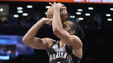 Apr 6, 2025; Brooklyn, New York, USA; Brooklyn Nets forward Tosan Evbuomwan (12) shoots a three point jump shot against the Toronto Raptors during the second half at Barclays Center. Mandatory Credit: Gregory Fisher-Imagn Images