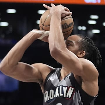 Apr 6, 2025; Brooklyn, New York, USA; Brooklyn Nets forward Tosan Evbuomwan (12) shoots a three point jump shot against the Toronto Raptors during the second half at Barclays Center. Mandatory Credit: Gregory Fisher-Imagn Images