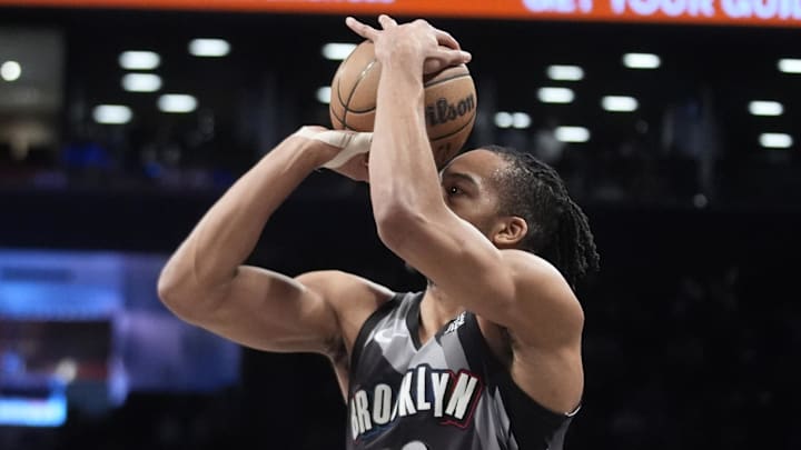 Apr 6, 2025; Brooklyn, New York, USA; Brooklyn Nets forward Tosan Evbuomwan (12) shoots a three point jump shot against the Toronto Raptors during the second half at Barclays Center. Mandatory Credit: Gregory Fisher-Imagn Images