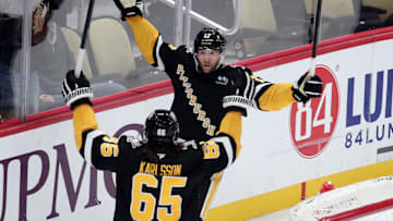 Dec 3, 2024; Pittsburgh, Pennsylvania, USA;  Pittsburgh Penguins right wing Bryan Rust (17) celebrates his game winning goal with defenseman Erik Karlsson (65) in overtime against the Florida Panthers at PPG Paints Arena. Mandatory Credit: Charles LeClaire-Imagn Images