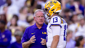 Sep 28, 2024; Baton Rouge, Louisiana, USA;  LSU Tigers quarterback Garrett Nussmeier (13) talks to head coach Brian Kelly during warmups before a game against the South Alabama Jaguars at Tiger Stadium. Mandatory Credit: Stephen Lew-Imagn Images