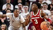 Arkansas Razorbacks forward Adou Thiero (3) drives against Texas A&M Aggies guard Wade Taylor IV (4) during the first half at Reed Arena.