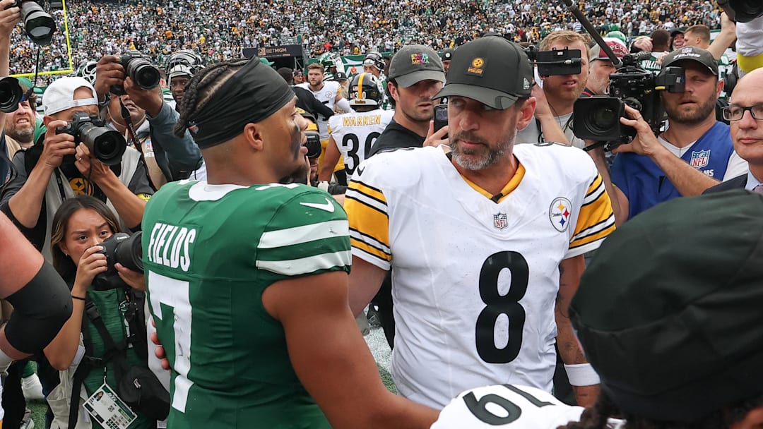 New York Jets quarterback Justin Fields (7) greets Pittsburgh Steelers quarterback Aaron Rodgers (8) after the game at MetLife Stadium.
