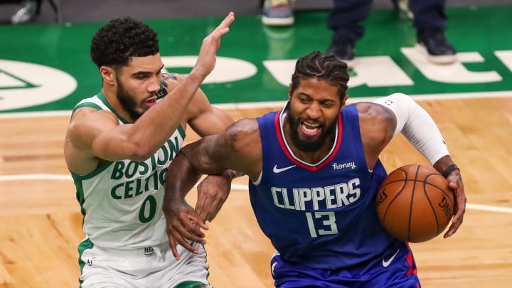 Boston, Massachusetts, USA; Los Angeles Clippers guard Paul George (13) drives to the basket defended by Boston Celtics forward Jayson Tatum (0) during the second half at TD Garden. Mandatory Credit: