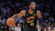 Apr 28, 2025; Miami, Florida, USA; Cleveland Cavaliers guard Donovan Mitchell (45) dribbles the basketball as Miami Heat guard Davion Mitchell (45) defends in the second quarter during game four for the first round of the 2025 NBA Playoffs at Kaseya Center. Mandatory Credit: Sam Navarro-Imagn Images