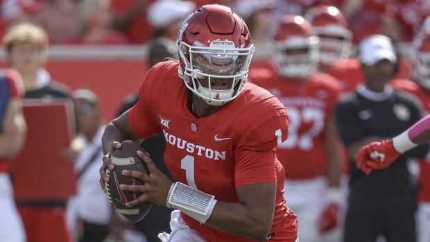 Houston Cougars quarterback Donovan Smith runs with the ball during a college football game in the Big 12.