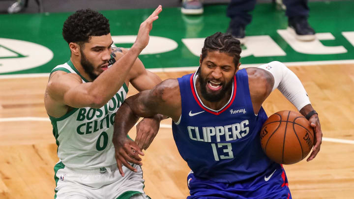 Mar 2, 2021; Boston, Massachusetts, USA; Los Angeles Clippers guard Paul George (13) drives to the basket defended by Boston Celtics forward Jayson Tatum (0) during the second half at TD Garden. Mandatory Credit: Paul Rutherford-USA TODAY Sports