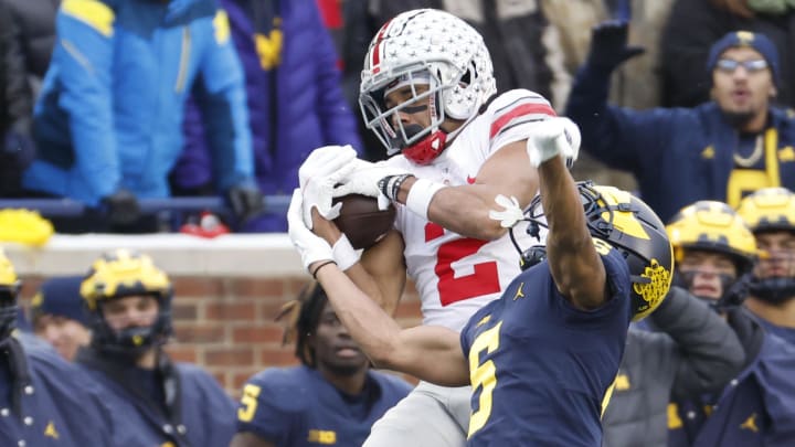 Nov 27, 2021; Ann Arbor, Michigan, USA; Ohio State Buckeyes wide receiver Chris Olave (2) makes a reception over Michigan Wolverines defensive back DJ Turner (5) at Michigan Stadium. Mandatory Credit: Rick Osentoski-USA TODAY Sports