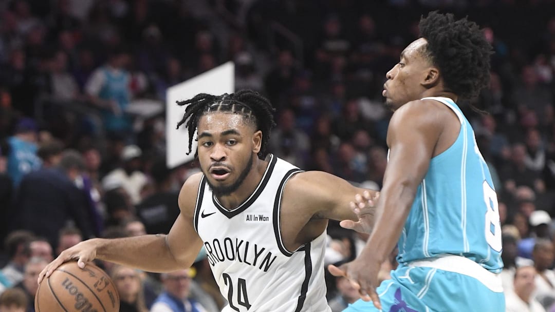 Oct 22, 2025; Charlotte, North Carolina, USA; Brooklyn Nets guard Cam Thomas (24) brings the ball down court past Charlotte Hornets guard Collin Sexton (8) during the first half at the Spectrum Center. Mandatory Credit: Sam Sharpe-Imagn Images