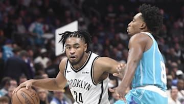 Oct 22, 2025; Charlotte, North Carolina, USA; Brooklyn Nets guard Cam Thomas (24) brings the ball down court past Charlotte Hornets guard Collin Sexton (8) during the first half at the Spectrum Center. Mandatory Credit: Sam Sharpe-Imagn Images