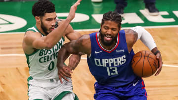 Mar 2, 2021; Boston, Massachusetts, USA; Los Angeles Clippers guard Paul George (13) drives to the basket defended by Boston Celtics forward Jayson Tatum (0) during the second half at TD Garden. Mandatory Credit: Paul Rutherford-USA TODAY Sports