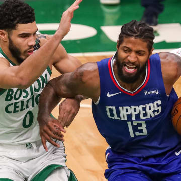 Mar 2, 2021; Boston, Massachusetts, USA; Los Angeles Clippers guard Paul George (13) drives to the basket defended by Boston Celtics forward Jayson Tatum (0) during the second half at TD Garden. Mandatory Credit: Paul Rutherford-USA TODAY Sports