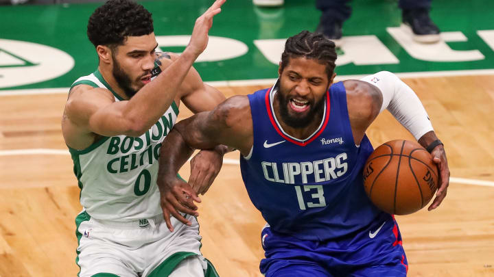 Mar 2, 2021; Boston, Massachusetts, USA; Los Angeles Clippers guard Paul George (13) drives to the basket defended by Boston Celtics forward Jayson Tatum (0) during the second half at TD Garden. Mandatory Credit: Paul Rutherford-USA TODAY Sports