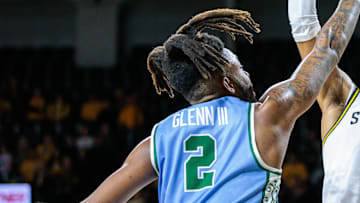 Feb 23, 2025; Wichita, Kansas, USA; Wichita State Shockers forward Corey Washington (6) shoots the ball over Tulane Green Wave forward Gregg Glenn III (2) during the second half at Charles Koch Arena