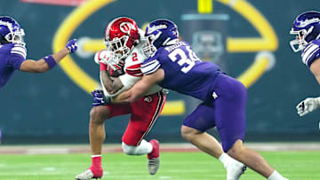 Dec 23, 2023; Las Vagas, NV, USA; Utah Utes running back Micah Bernard (2) is tackled by Northwestern Wildcats linebacker Xander Mueller (34) during the first quarter at Allegiant Stadium. Mandatory Credit: Stephen R. Sylvanie-Imagn Images
