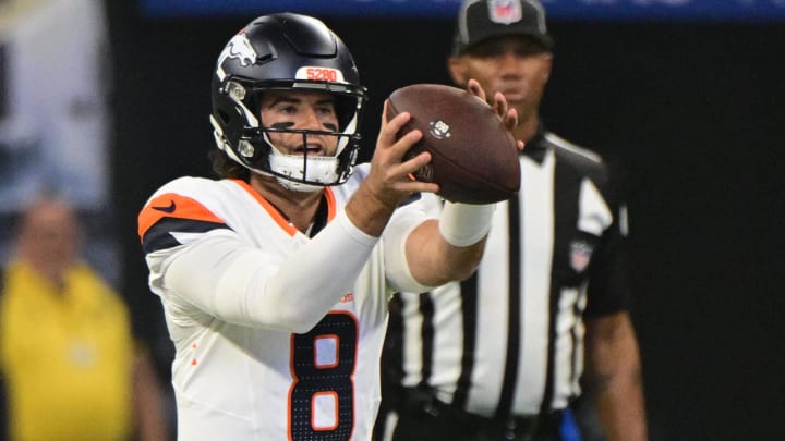 Aug 11, 2024; Indianapolis, Indiana, USA; Denver Broncos quarterback Jarrett Stidham (8) takes the snap during the first quarter against the Indianapolis Colts at Lucas Oil Stadium. 