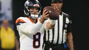 Aug 11, 2024; Indianapolis, Indiana, USA; Denver Broncos quarterback Jarrett Stidham (8) takes the snap during the first quarter against the Indianapolis Colts at Lucas Oil Stadium. Mandatory Credit: Marc Lebryk-USA TODAY Sports