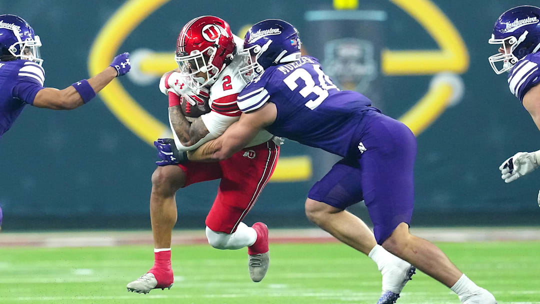 Dec 23, 2023; Las Vagas, NV, USA; Utah Utes running back Micah Bernard (2) is tackled by Northwestern Wildcats linebacker Xander Mueller (34) during the first quarter at Allegiant Stadium. Mandatory Credit: Stephen R. Sylvanie-Imagn Images