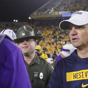 Sep 7, 2024; Morgantown, West Virginia, USA; West Virginia Mountaineers head coach Neal Brown speaks with Albany Great Danes head coach Greg Gattuso after the game at Mountaineer Field at Milan Puskar Stadium. Mandatory Credit: Ben Queen-Imagn Images