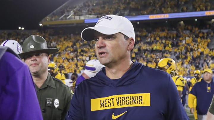 Sep 7, 2024; Morgantown, West Virginia, USA; West Virginia Mountaineers head coach Neal Brown speaks with Albany Great Danes head coach Greg Gattuso after the game at Mountaineer Field at Milan Puskar Stadium. Mandatory Credit: Ben Queen-Imagn Images