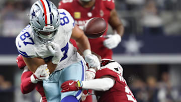 Nov 3, 2025; Arlington, Texas, USA; Dallas Cowboys tight end Jake Ferguson (87) fumbles against Arizona Cardinals linebacker Mack Wilson Sr. (2) and cornerback Garrett Williams (21) in the first half at AT&T Stadium.