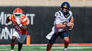 Oct 5, 2024; Stillwater, Oklahoma, USA; West Virginia Mountaineers quarterback Garrett Greene (6) scrambles in the backfield against the Oklahoma State Cowboys during the second quarter at Boone Pickens Stadium. Mandatory Credit: William Purnell-Imagn Images