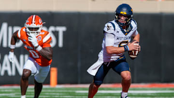 Oct 5, 2024; Stillwater, Oklahoma, USA; West Virginia Mountaineers quarterback Garrett Greene (6) scrambles in the backfield against the Oklahoma State Cowboys during the second quarter at Boone Pickens Stadium. Mandatory Credit: William Purnell-Imagn Images