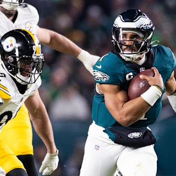Dec 15, 2024; Philadelphia, Pennsylvania, USA; Philadelphia Eagles quarterback Jalen Hurts (1) runs with the ball in front of Pittsburgh Steelers linebacker T.J. Watt (90) during the third quarter at Lincoln Financial Field. Mandatory Credit: Bill Streicher-Imagn Images
