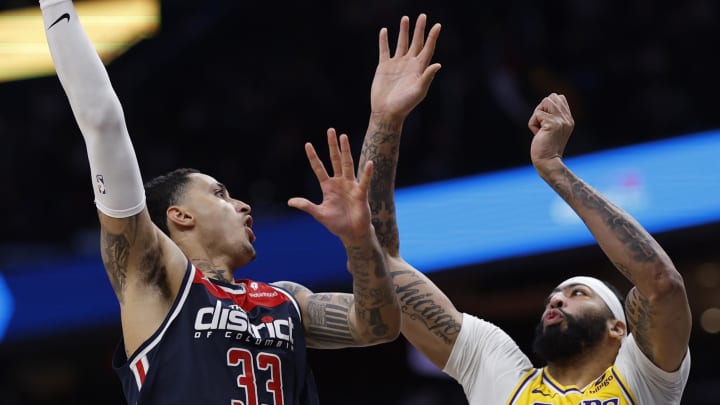 Apr 3, 2024; Washington, District of Columbia, USA; Los Angeles Lakers forward Anthony Davis (3) attempts to block the shot of Washington Wizards forward Kyle Kuzma (33) at Capital One Arena. Mandatory Credit: Geoff Burke-USA TODAY Sports