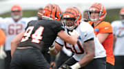 Cincinnati Bengals offensive guard Michael Jordan (60) blocks Cincinnati Bengals defensive end Sam Hubbard (94) as Cincinnati Bengals quarterback Andy Dalton (14) takes the snap during Cincinnati Bengals training camp practice, Tuesday, Aug. 13, 2019, at the practice fields next to Paul Brown Stadium in Cincinnati.

Cincinnati Bengals Training Camp Aug 13