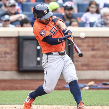 Jun 30, 2024; New York City, New York, USA;  Houston Astros second baseman Jose Altuve (27) hits an RBI single in the fifth inning against the New York Mets at Citi Field. 