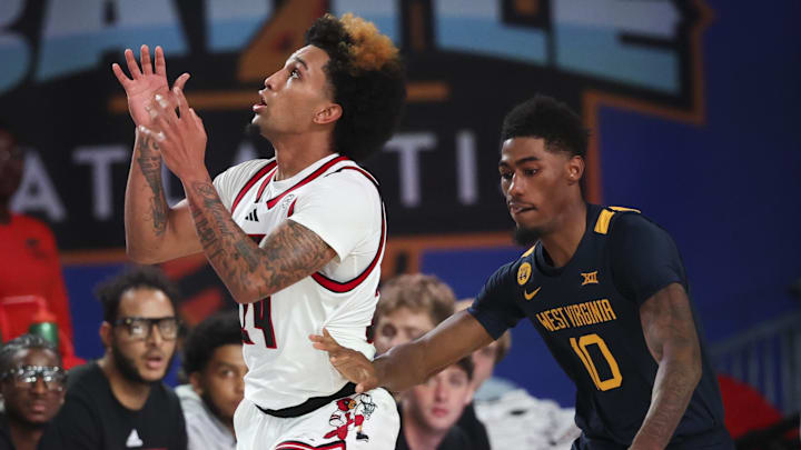 Nov 28, 2024; Paradise Island, Bahamas, BHS;  Louisville Cardinals guard Chucky Hepburn (24) grabs the ball as West Virginia Mountaineers guard Sencire Harris (10) defends during the second half at Imperial Arena at the Atlantis resort.  Mandatory Credit: Kevin Jairaj-Imagn Images