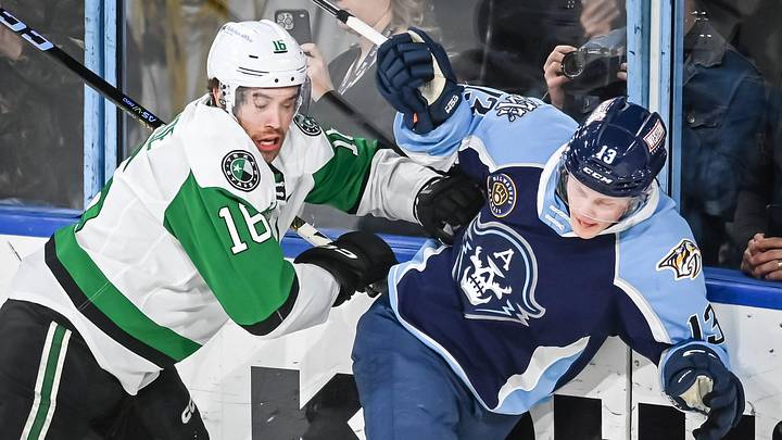 Texas Stars left wing Curtis McKenzie (16) and Milwaukee Admirals center Juuso Parssinen (13) crash into the glass during the second period of their game Saturday, February 10, 2024, at the UW-Milwaukee Panther Arena in Milwaukee, Wisconsin.