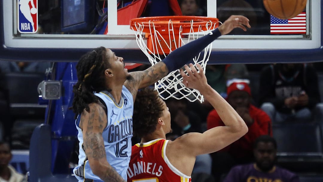 Jan 21, 2026; Memphis, Tennessee, USA; Memphis Grizzlies guard Ja Morant (12) blocks a shot attempt by Atlanta Hawks guard Dyson Daniels (5) during the fourth quarter at FedExForum. Mandatory Credit: Petre Thomas-Imagn Images